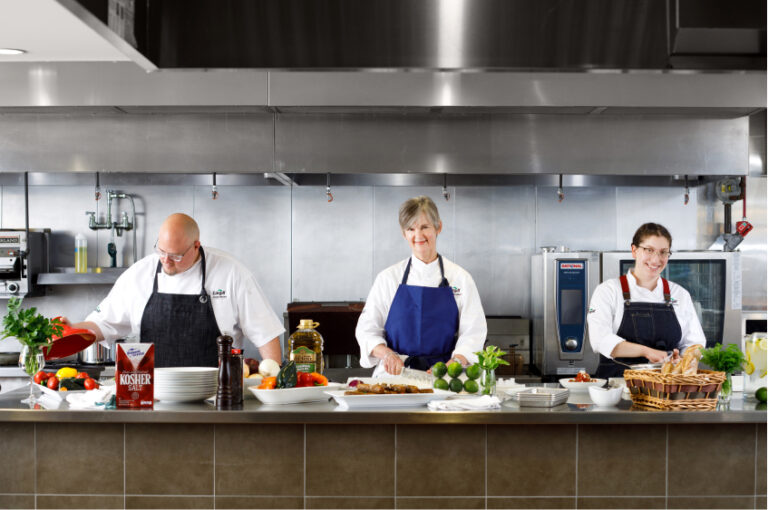 chef and workers in a commercial kitchen