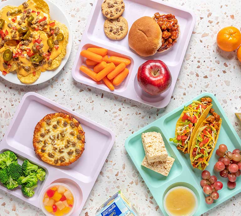 school lunches with nachos, tacos, pizza and sloppy joe